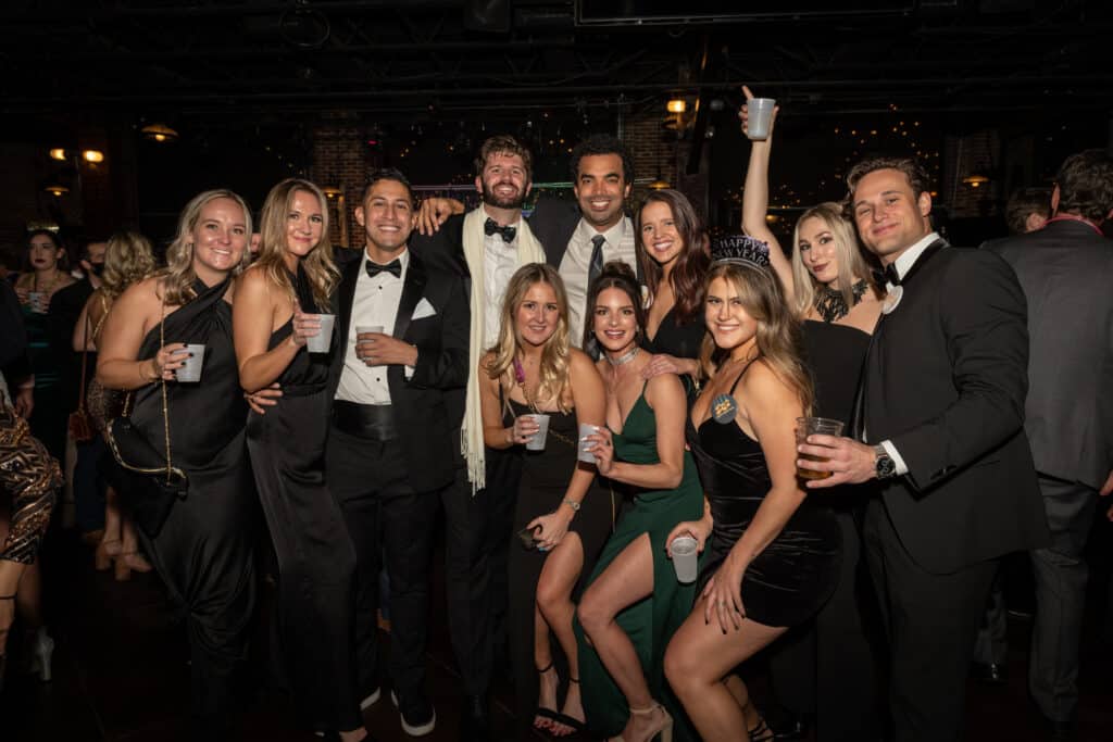 people at the Denver NYE Black tie party with drinks from the open bar 